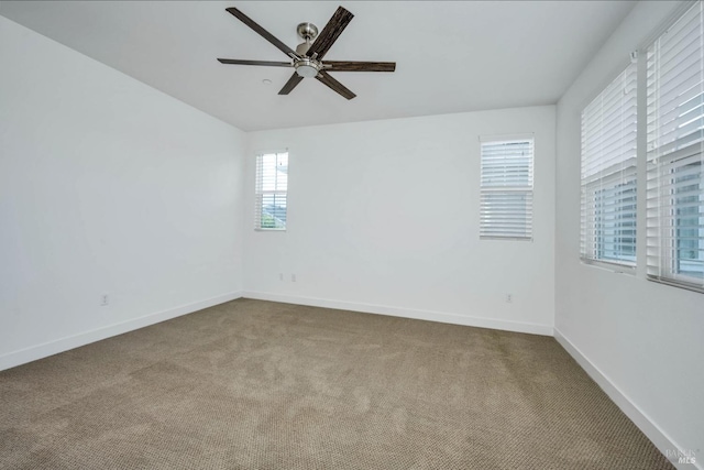 carpeted empty room featuring ceiling fan