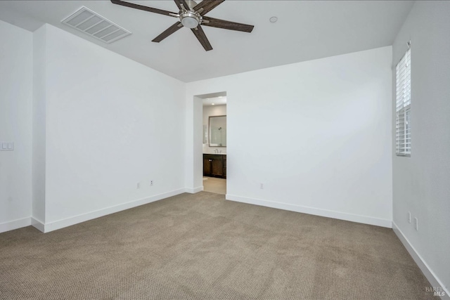 carpeted spare room featuring ceiling fan