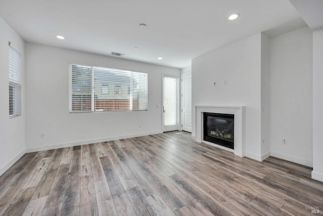 unfurnished living room featuring hardwood / wood-style floors