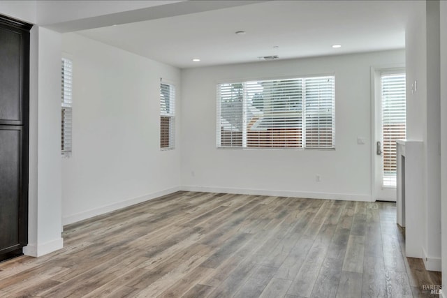 unfurnished room with light hardwood / wood-style floors