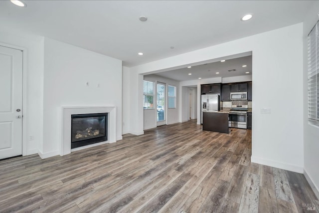 unfurnished living room featuring hardwood / wood-style floors