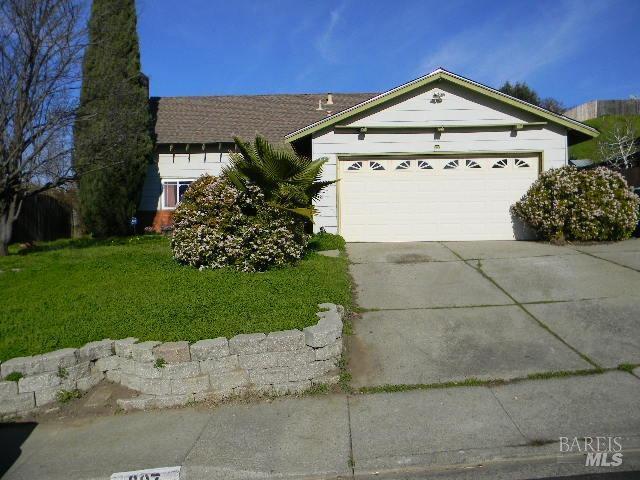 ranch-style house with a garage and a front yard