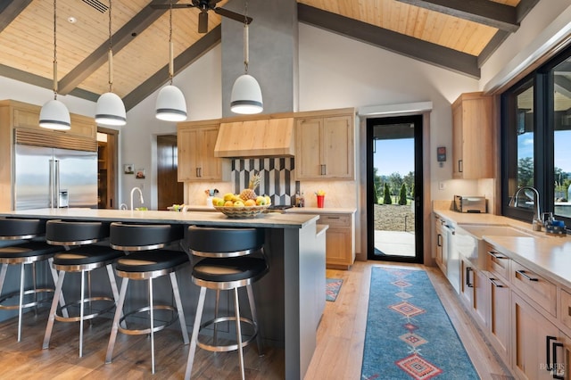 kitchen featuring beamed ceiling, stainless steel built in fridge, wooden ceiling, and decorative backsplash