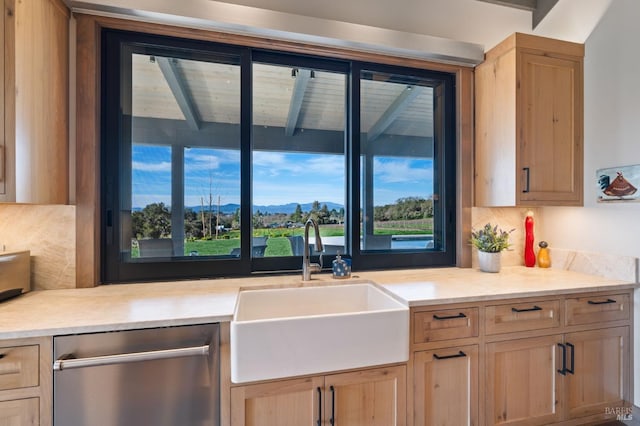 kitchen featuring a mountain view, sink, dishwasher, and light brown cabinets