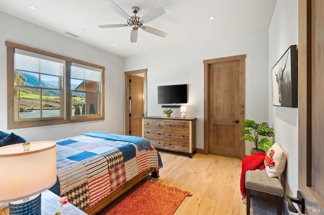 bedroom with light hardwood / wood-style floors and ceiling fan