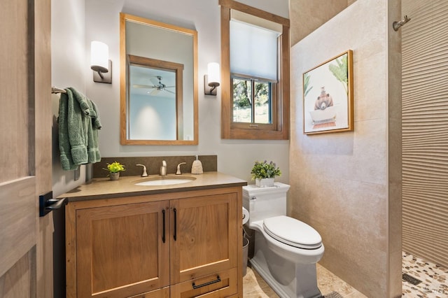 bathroom featuring vanity, toilet, and a tile shower