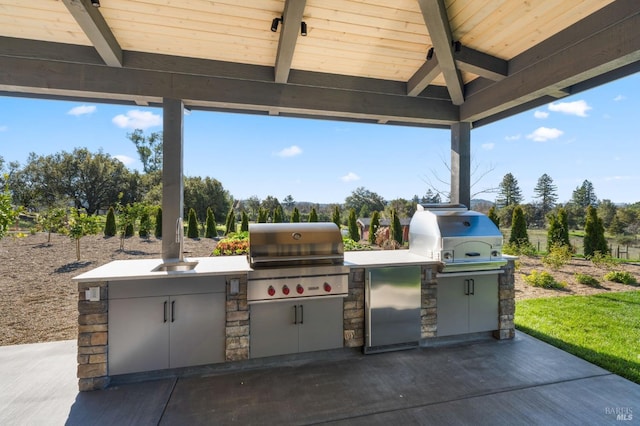 view of patio featuring area for grilling and a grill