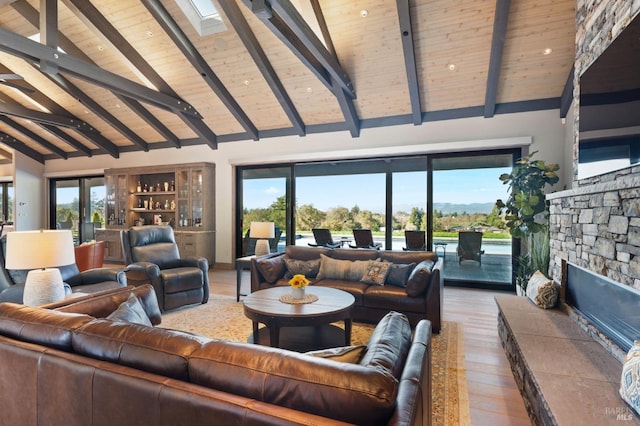 living room featuring beam ceiling, hardwood / wood-style floors, and wooden ceiling