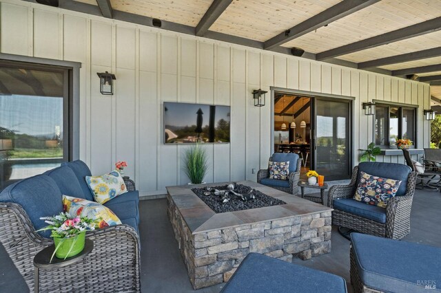 view of patio / terrace with an outdoor living space with a fire pit