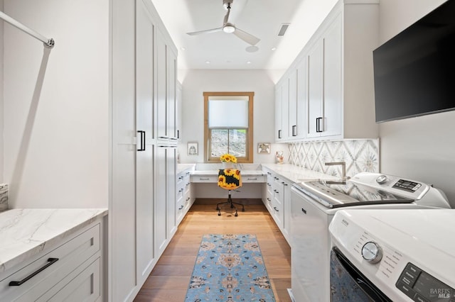 washroom with ceiling fan, cabinets, separate washer and dryer, and light hardwood / wood-style floors