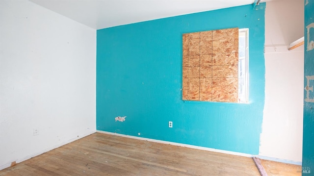 spare room featuring wood-type flooring