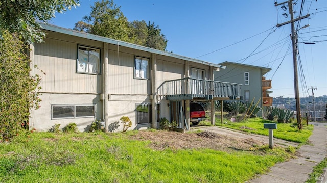 exterior space featuring a deck and a lawn