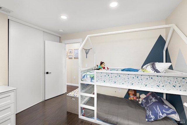 bedroom with dark hardwood / wood-style flooring