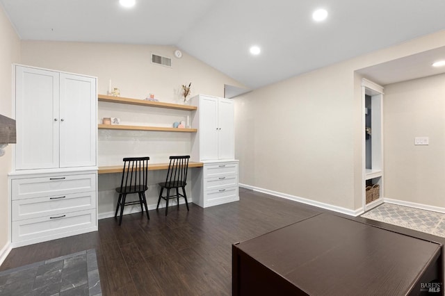 office area with lofted ceiling, built in desk, and dark hardwood / wood-style flooring