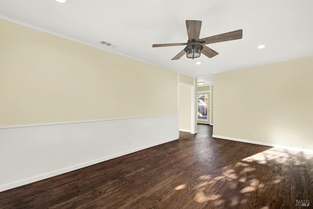 empty room featuring dark hardwood / wood-style flooring and ceiling fan