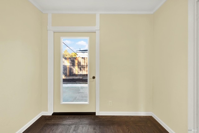 doorway with ornamental molding, a healthy amount of sunlight, and dark parquet flooring