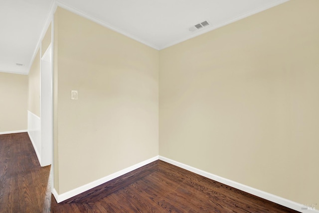 empty room featuring ornamental molding and dark hardwood / wood-style floors