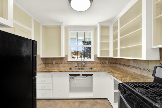 kitchen with light stone counters, sink, white cabinetry, and black appliances