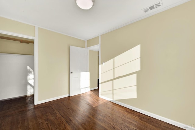 unfurnished bedroom with ornamental molding, wood-type flooring, and a closet