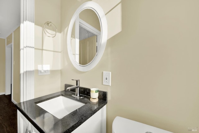 bathroom featuring vanity, toilet, and hardwood / wood-style floors