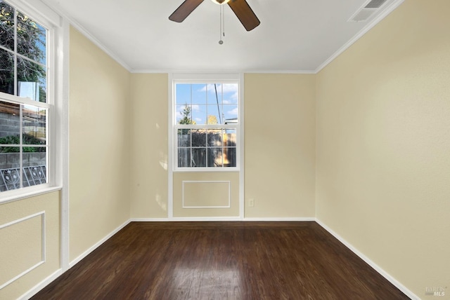 unfurnished room featuring crown molding, ceiling fan, dark hardwood / wood-style floors, and a wealth of natural light