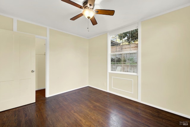 empty room featuring ceiling fan and dark hardwood / wood-style floors