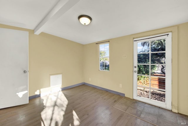 empty room featuring beam ceiling and hardwood / wood-style floors