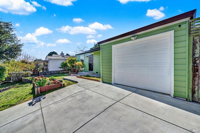 view of front of property with a garage and a front lawn