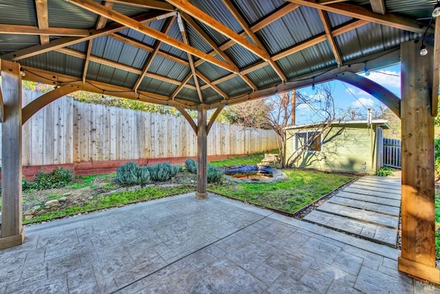 view of patio featuring a gazebo and an outbuilding