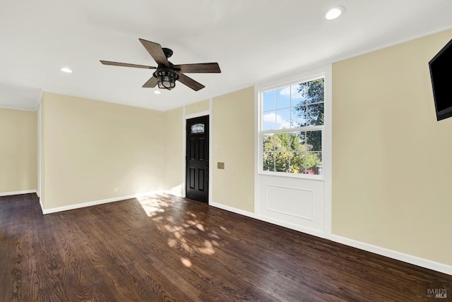 unfurnished room featuring dark hardwood / wood-style floors and ceiling fan