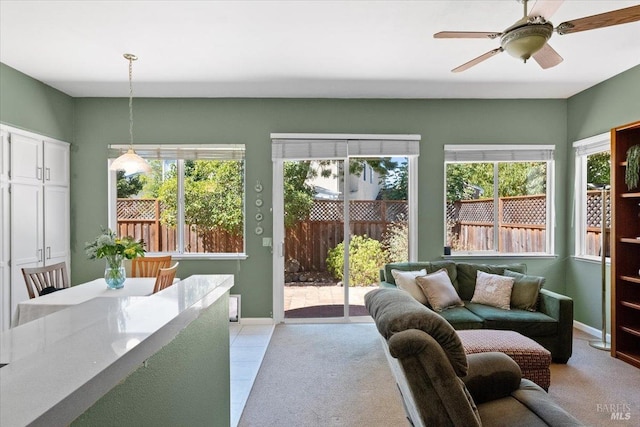 sunroom featuring ceiling fan