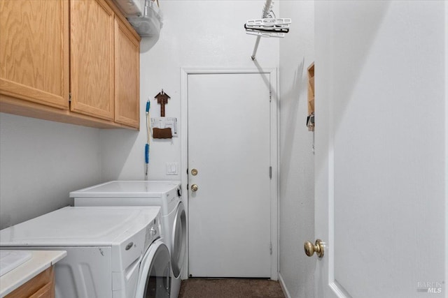 clothes washing area with cabinets and washer and clothes dryer