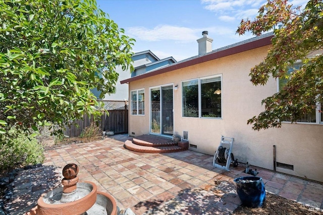 back of property with a patio