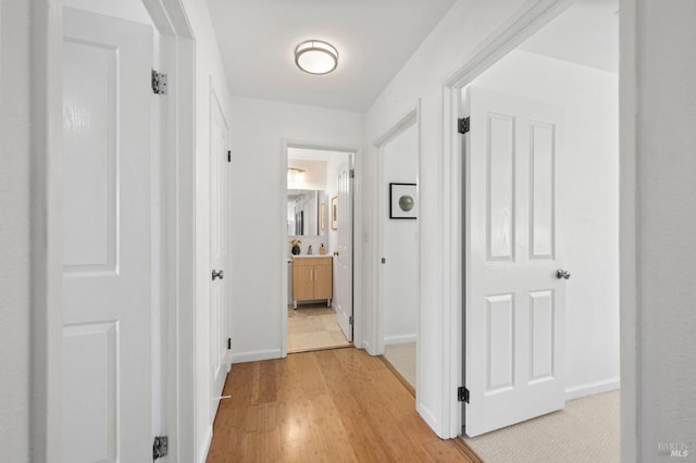 hall with light hardwood / wood-style floors