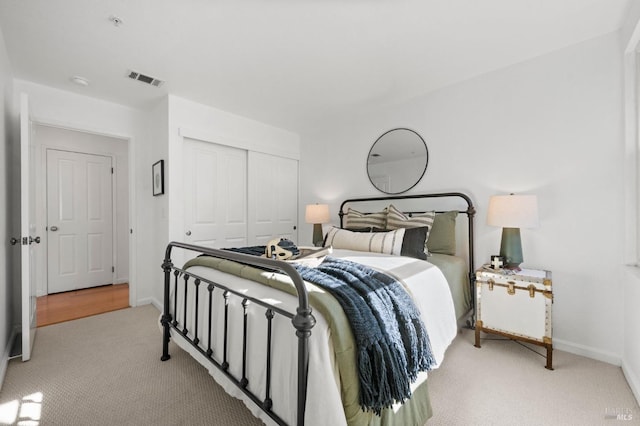 carpeted bedroom featuring a closet