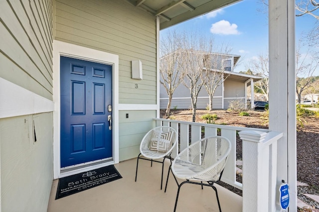 view of exterior entry with covered porch