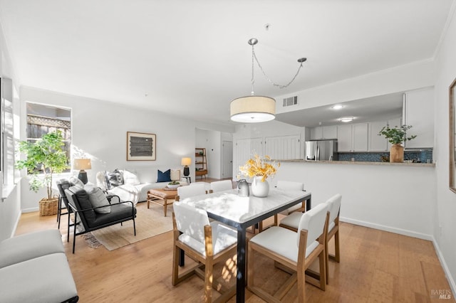 dining room with light hardwood / wood-style flooring