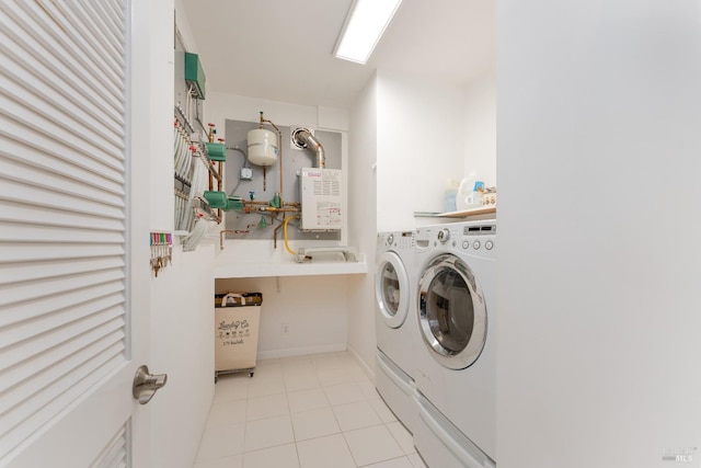 laundry room featuring light tile patterned floors and washing machine and dryer