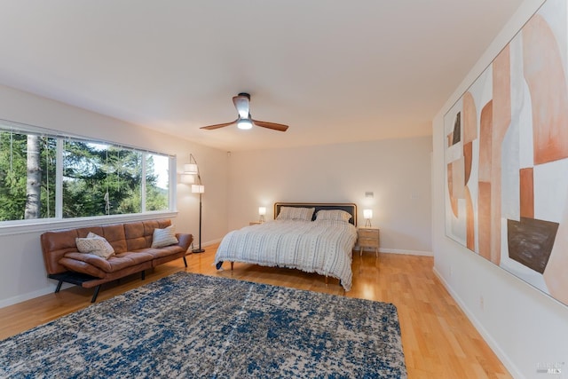 bedroom with ceiling fan and light hardwood / wood-style flooring