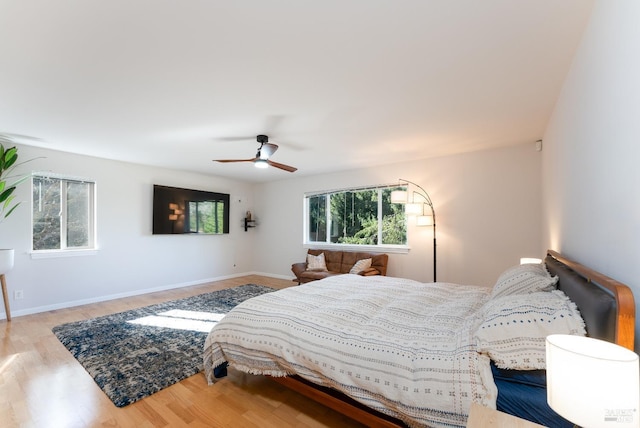 bedroom featuring ceiling fan, wood finished floors, and baseboards