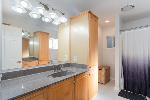 bathroom with visible vents, a shower with shower curtain, tile patterned flooring, and vanity