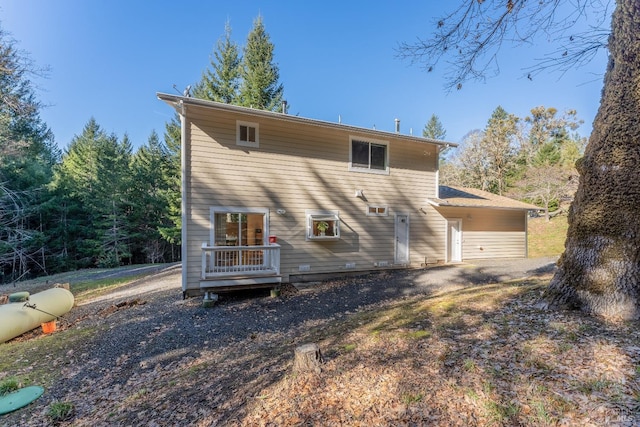 back of house featuring a wooden deck