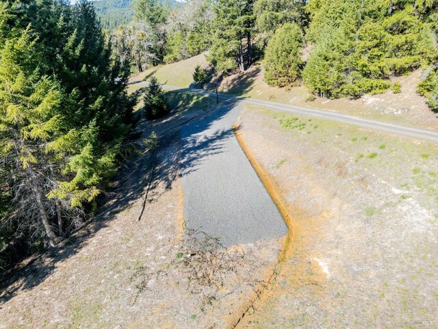 drone / aerial view featuring a wooded view