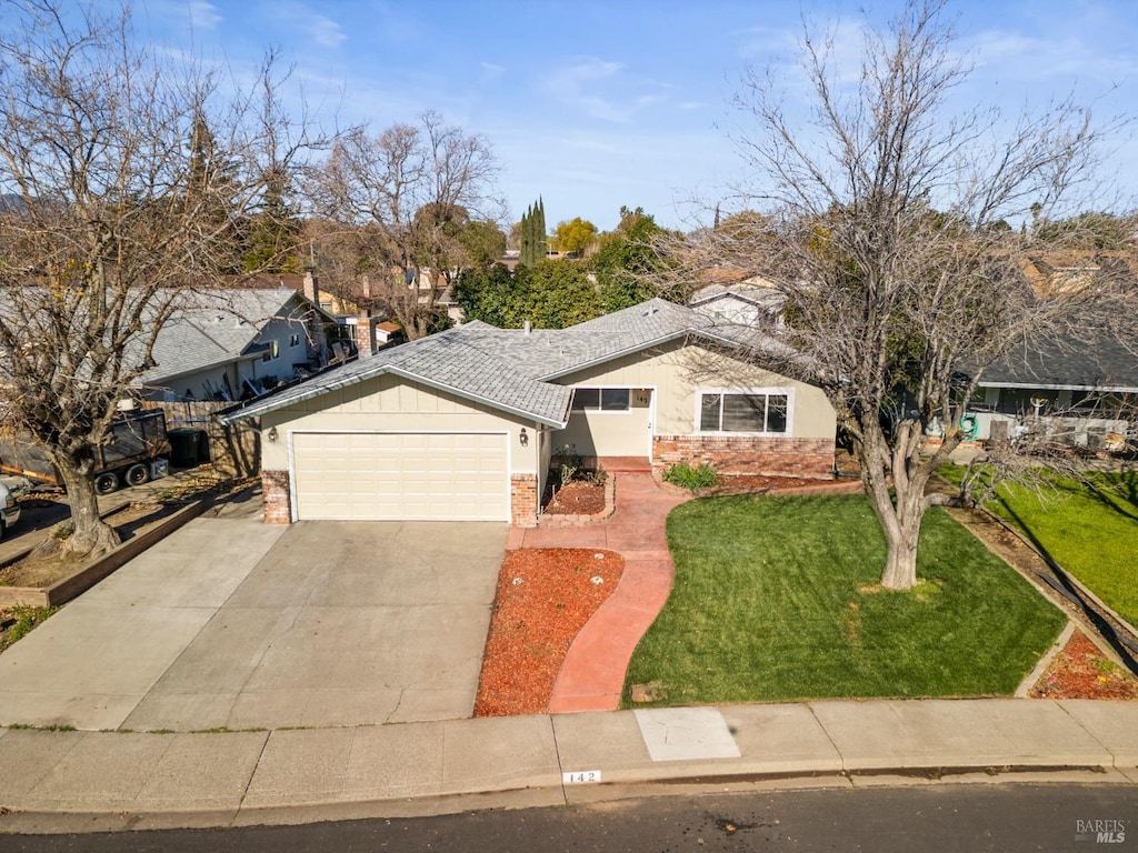 view of front of property featuring a garage and a front yard