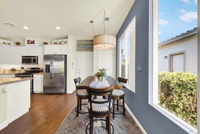 dining room with dark wood-type flooring