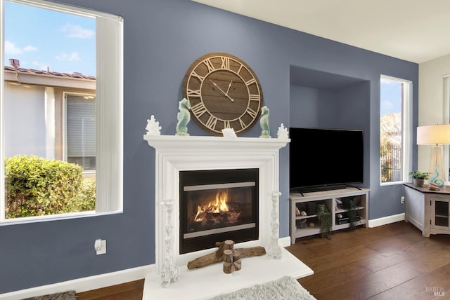 interior space with plenty of natural light and dark hardwood / wood-style floors