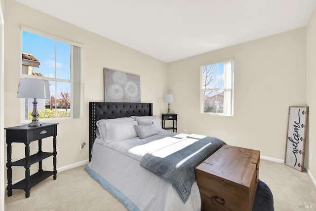 carpeted bedroom with multiple windows