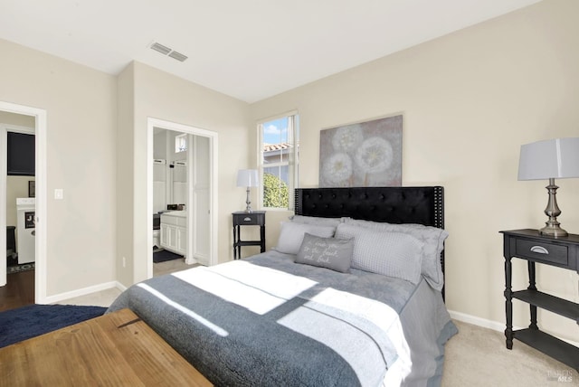 carpeted bedroom featuring ensuite bathroom