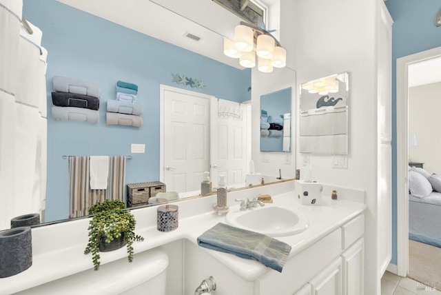 bathroom with tile patterned floors, vanity, and toilet