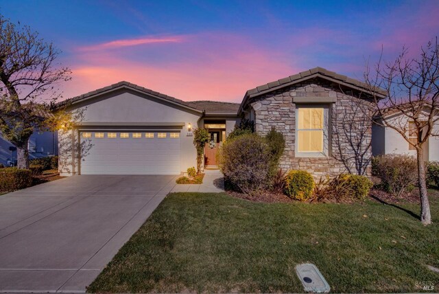 view of front of house with a yard and a garage